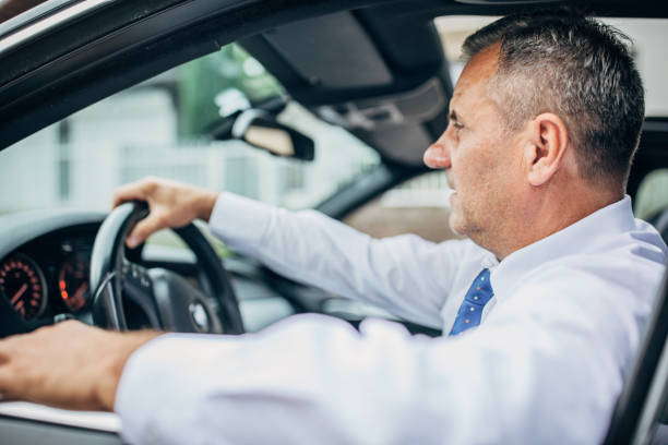 istock Senior successful businessman driving car 1179560361