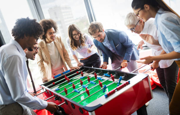 istock Colleagues playing table football in the break. 1179560612