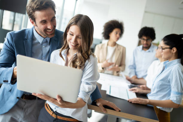 istock Happy business colleagues in modern office working together 1179560719