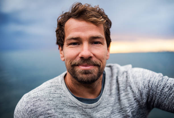 istock A portrait of handsome man standing outdoors, looking at camera. 1179560822