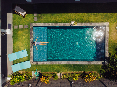 Woman floating on pool at Bali