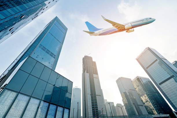 istock Airplane flying over modern buildings in the city 1179562014
