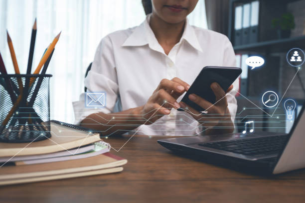 istock business woman working from home using smartphone and computer 1179562138
