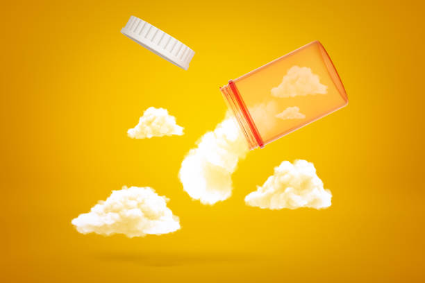 3d rendering of transparent orange medicine jar tilted down in air with white fluffy clouds emerging out of it on yellow background. 3d rendering of transparent orange medicine jar tilted down in air with white fluffy clouds emerging out of it on yellow background. Sweet dreams. Side effects of sleeping pills. Meds affect health. brain jar stock pictures, royalty-free photos & images