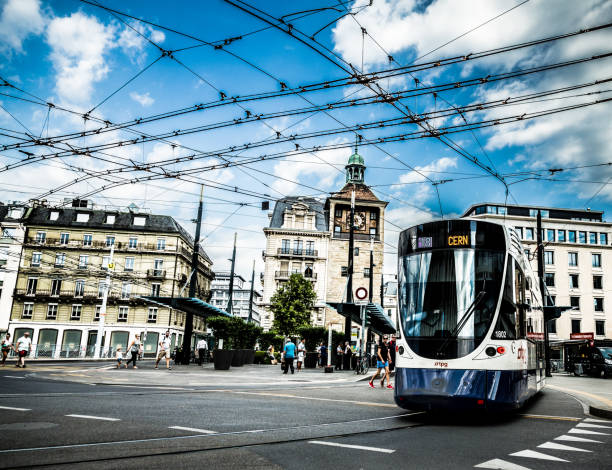 Geneva, Switzerland - 6 Augist, 2019: Color image depicting trams filled with people on the streets of downtown Geneva, Switzerland. Room for copy space.