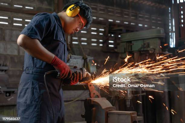 Asian Mechanical Engineer Operating Power Tools With Metal Sparks And Copy Space Stock Photo - Download Image Now