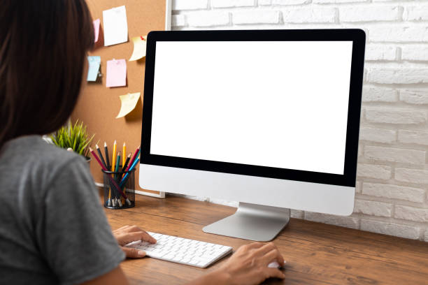 istock woman working empty screen computer on wood desk in home office. 1179565683