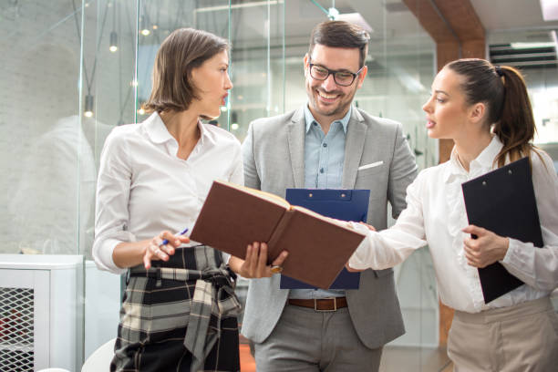 istock Business team discussing documents during an informal meeting in office lobby 1179565925