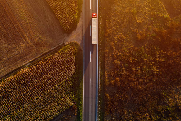 istock Truck on the road in sunset, top view 1179565984