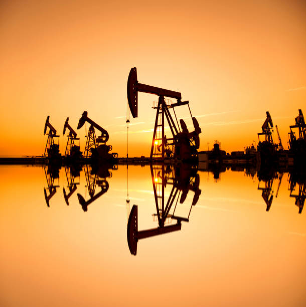 istock Oil pumps and rig at sunset 1179566668