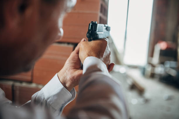 istock An elderly detective with a gun in action 1179566966