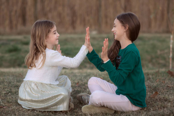 istock Happy funny sisters playing and laughing outdoors during autumn 1179567219