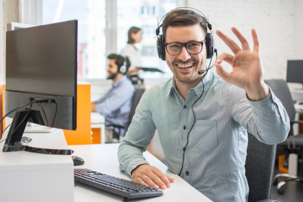 istock Happy handsome technical support operator with headset showing okey gesture to the camera 1179567352