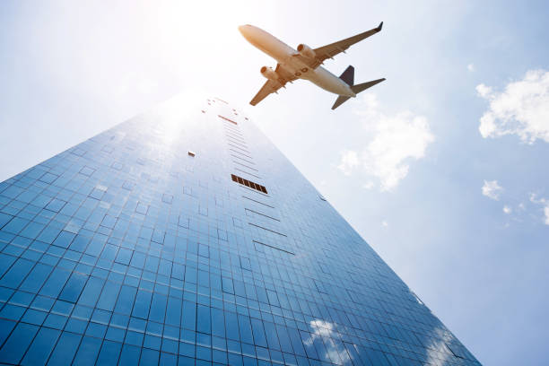 istock Modern skyscrapers and plane flying overhead 1179567543