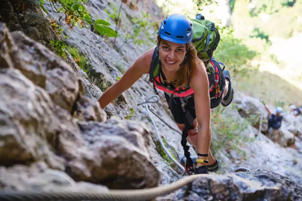 Photo of Happy woman climbing a via ferrata route in Turda Gorge (Cheile Turzii), Romania.