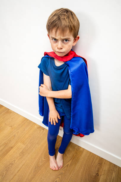 hurt sad superhero child feeling denigrated, frustrated, scared by parenthood hurt sad superhero child feeling denigrated, frustrated, scared, disappointed by parenthood and education through his body language denigrate stock pictures, royalty-free photos & images