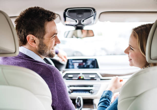 istock Happy young couple sitting in car, talking. 1179570540