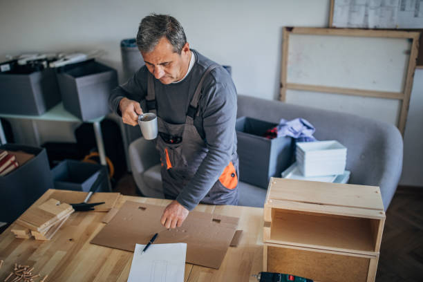 istock Carpenter looking at the sketch he draw 1179572954