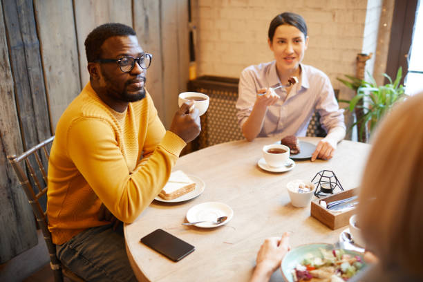 istock People Enjoying Lunch in Cozy Cafe 1179573109