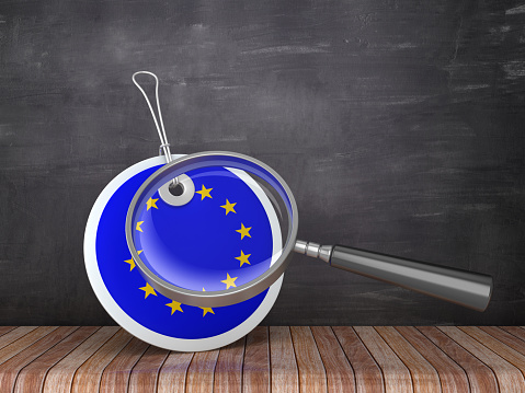 European Union Flag Price Tag with Magnifying Glass on Chalkboard Background - 3D Rendering