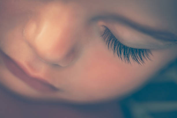 Sweet little girl in a outdoor shadowy portrait from the mouth up. Her eyes look up to the heavens. A blue, blue sky above her.