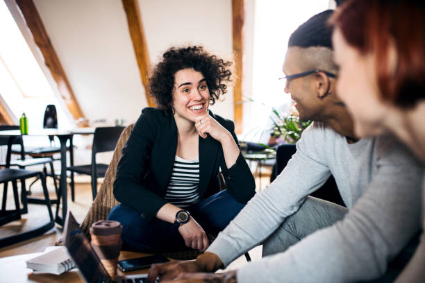 istock Group of young businesspeople using laptop in office, start-up concept. 1179574591