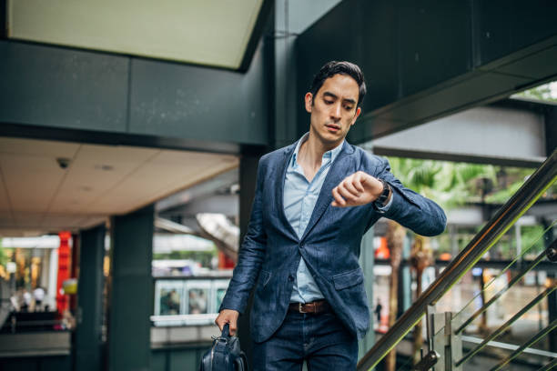 istock Young gentleman in a hurry checking the time 1179576567