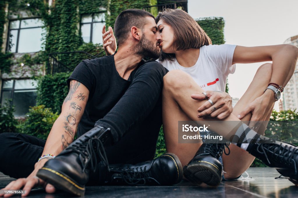 Cool couple in love Cool couple in love sitting on the street and kissing Couple - Relationship Stock Photo