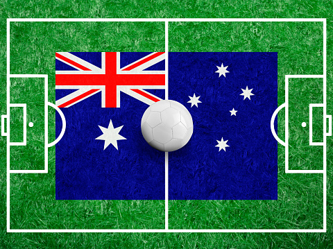 Soccer ball with a flag of Australia on green grass and field Lines