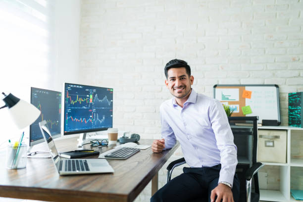 istock Confident Handsome Young Stock Broker Working At Home 1179580556