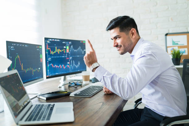 istock Handsome Stock Broker Gesturing While Trading Online 1179580677