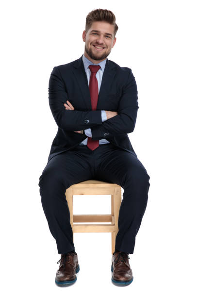 istock happy young businessman sitting with arms folded 1179580857
