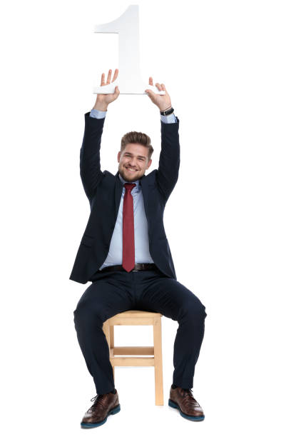 istock enthusiastic young businessman holding number one sign 1179580881
