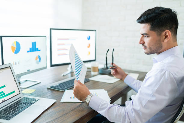 Handsome Latin Businessman Examining Sales Data
