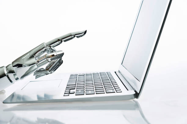 istock Robot's finger pointing to computer monitor 1179581795
