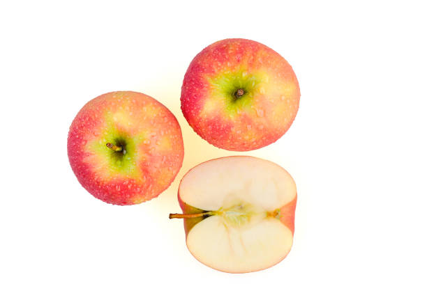 istock Sliced wet red apples isolated on white background ready to use in designs 1179581954
