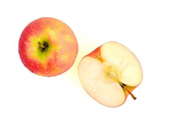 istock Sliced wet red apples isolated on white background ready to use in designs 1179581980