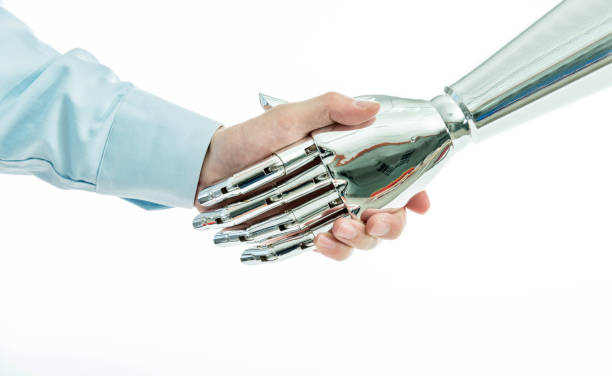 istock Businessman and robot shaking hands on white background 1179582074