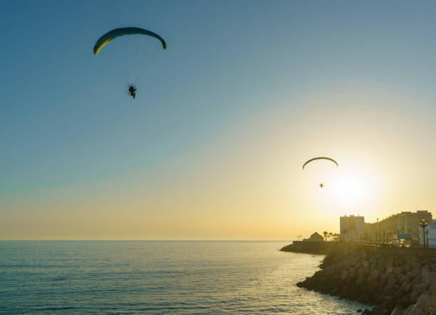 istock Two paragliders in Cadiz sky on sunset time 1179583550