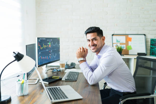 istock Happy Attractive Young Stock Broker Working At Home 1179583776