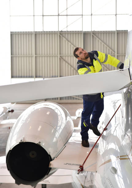 istock Airport workers check an aircraft for safety in a hangar 1179583861
