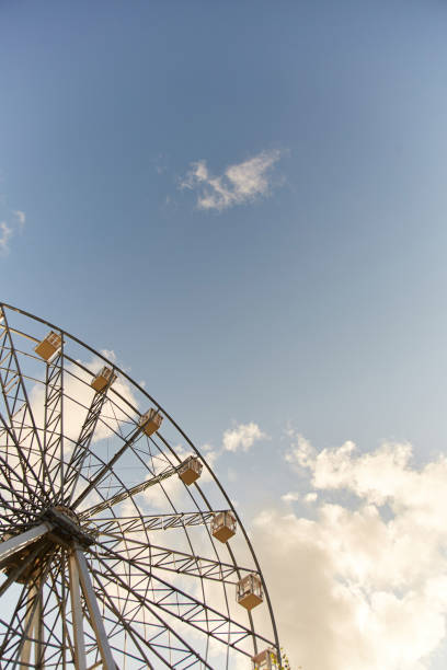 Ferris wheel. Amusement park. Ferris wheel booths on sky background.