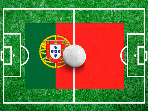 Soccer ball with a flag of Portugal on green grass and field Lines