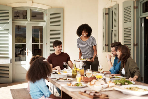 Love, family and laughter Shot of a group of people sharing a meal dinner party stock pictures, royalty-free photos & images