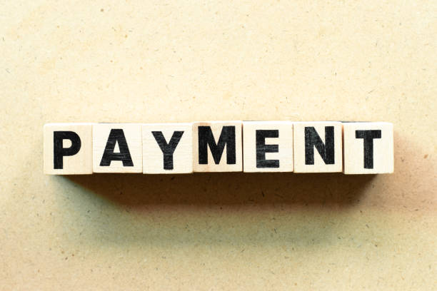 istock Letter block in word payment on wood background 1179584938