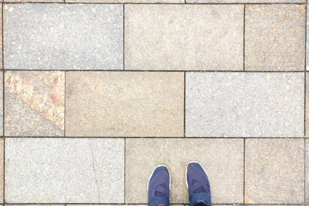 istock Large stone tiles and shoes, background, copy space 1179586898