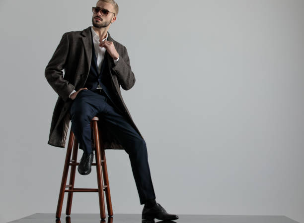 istock businessman sitting one leg resting and looking sideways intrigued 1179586917