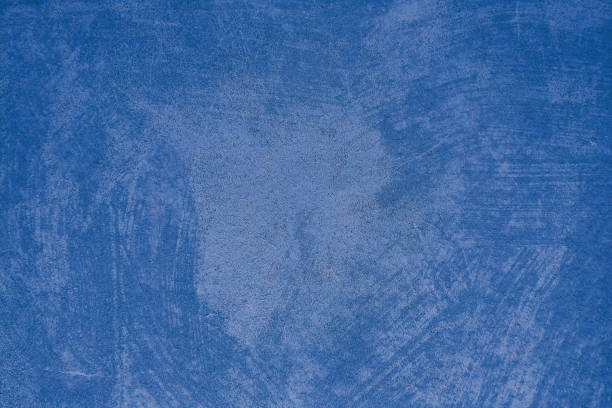 istock Dark blue paint background on concrete wall with uneven surface, texture 1179588372