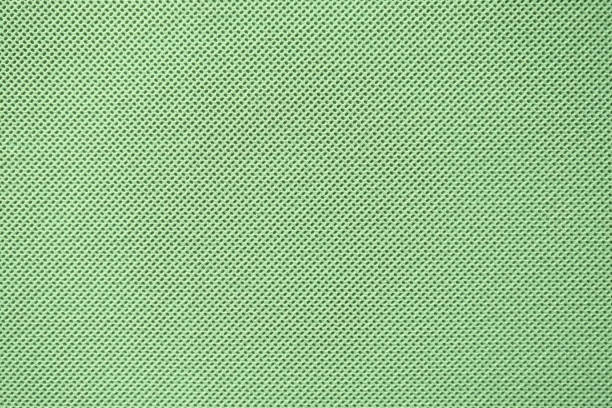 istock Fabric texture with small holes, green background 1179588446