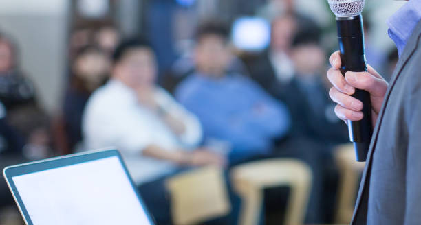 istock Meeting presenter. Conference with business people training and learning. Coaching Concept with blurred background. Speaker talking to audience in hall during seminar event. Lecture series speech. 1179588893